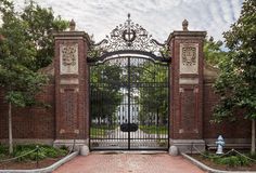 an iron gate in front of a brick building