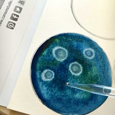 a blue and green plate with circles painted on it