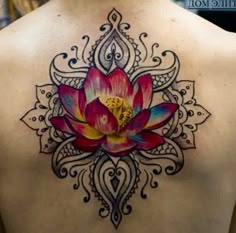 a lotus tattoo on the back of a woman