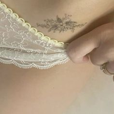 a close up of a woman's stomach with tattoos on her chest and bra