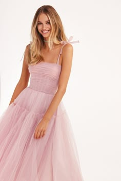 Delicate dress made from swathes of pink tulle. Designed in an A-line silhouette, it has a romantic straight neckline with straps and lacing on the back. A puffy skirt is made from layers of delicate tulle fabric. Details: Material: Tulle Fabric composition: 100% polyester Sleeve style: Tulle straps Silhouette: A-line Skirt length from waist: 33.07 inches / 84 cm Dress weight: 1.32 lbs / 0.6 kg Neckline: Straight neckline Back: Lace-up closure Lining: Pink knee-length flared underskirt Model is Romantic Tulle Dress, Carnation Pink Dress, Cocktail Tulle Dress, Pink Romantic Dress, Light Pink Tulle Dress, Bridesmaid Tulle Dress, Corset Tulle Dress, Light Pink Dresses, Pink Rose Dress