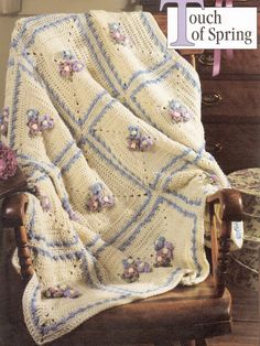 a crocheted blanket sitting on top of a wooden chair