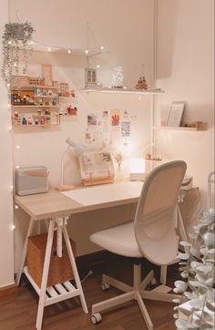 a white desk with a chair next to it and some lights on the wall behind it