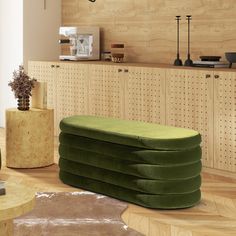 a green bench sitting in front of a wooden wall with pegboard on it's sides