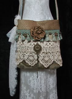 the purse is made from lace and has a flower on it's side,