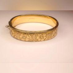 Floral Dunn Bros. G.F On Sterling Hinged Bangle Bracelet Stamped/Engraved; 1/20 Gold Filled On Sterling Bangle Bracelet That Has An Ornate Floral Design Around The Entire Bangle. Width: 1/4" External Dimensions: 7 3/4" Length Fits Up To A 7" Wrist 2mm Thickness Slide In Clasp Closes Securely. Fabulous Condition, Well Maintained, No Brassing Or Fading. Heirloom Engraved Bracelet For Formal Occasions, Elegant Engraved Cuff Bracelet For Formal Occasions, Elegant Engraved Cuff Bracelet For Formal, Elegant Etched Bangle For Wedding, Adjustable Engraved Bangle For Formal Occasions, Heirloom Gold Hinged Bracelets, Heirloom Gold Hinged Bracelet, Elegant Etched Bracelets For Wedding, Engraved Bangle Bracelet For Wedding