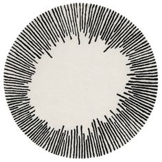 a black and white circular rug with lines on the bottom, in front of a white background