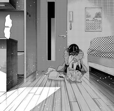 a black and white image of a person sitting on the floor in front of a bed