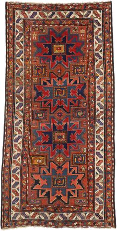 73306 Antique Caucasian Kazak Rug, 04'04 X 08'07. Based on traditional designs from the Caucasus region, this hand-knotted wool antique Russian Kazak rug features four Lesghi Stars surrounded by classic Caucasian motifs representing protection, longevity and fertility. This antique Kazak rug depicts a human figure in two of the corners, indicating the weaver was pregnant or possibly it was a wedding gift. It is finished with a leaf and calyx style (wine glass) border flanked with subsidiary mean Wide Hallway, Persian Rug Designs, The Weaver, Scandinavian Rug, Caucasian Rug, Human Figure, Rugs And Carpet, Shades Of Red, Fashion Room