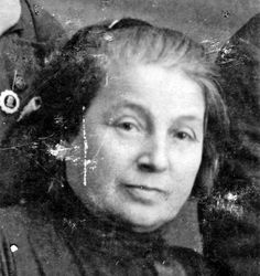 an old black and white photo of a woman with eyeballs in her hair, looking at the camera