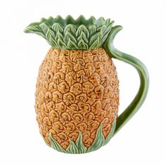 a ceramic pineapple mug with green leaves on it