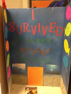 a cardboard box with writing on it that says i survived the science fair at school