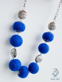 a necklace with blue balls and silver chains