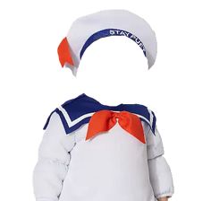 a little boy dressed up in a sailor outfit with an orange and blue bow on his head