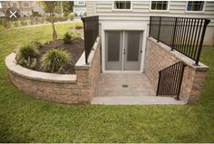 a brick wall and gate in front of a house