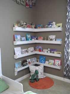 a child's room with bookshelves on the wall and stuffed animals in the corner