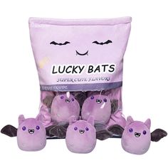 the stuffed toys are purple and have bats on them