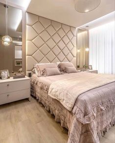 a bedroom with a bed, dresser and mirror on the wall next to it's headboard