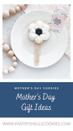 a mother's day gift idea with cookies and flowers on the plate next to it