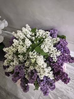 purple and white flowers are in a vase