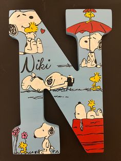 the letter n is made up of wood and has cartoon characters on it, including a snoop