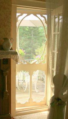 an open window in a room with white curtains