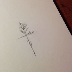 a pencil drawing of a flower on a piece of paper that is laying on a table