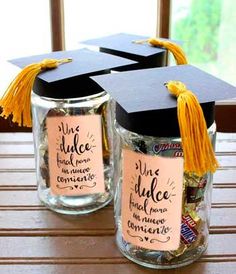 two jars with graduation caps and tassels on them