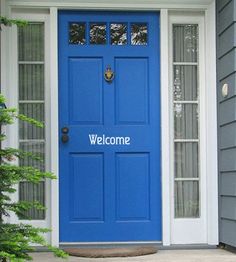 a blue front door on a gray house