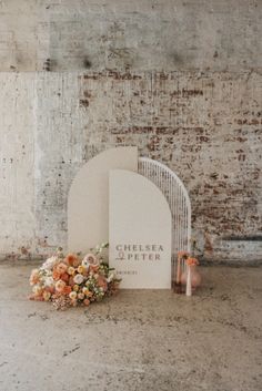 flowers are placed next to a sign in front of a brick wall that says cireta