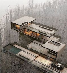 an aerial view of a house in the woods