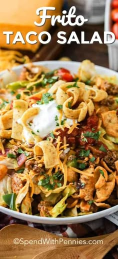 a white bowl filled with taco salad on top of a table