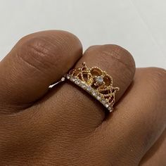 a woman's hand with a gold and diamond ring