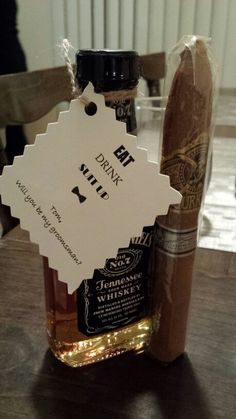 a bottle of liquor sitting on top of a wooden table next to a bag of cigars