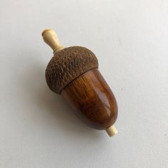 an acorn is sitting on top of a white surface