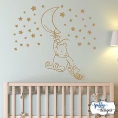 winnie the pooh wall decal with stars on it in a baby's room