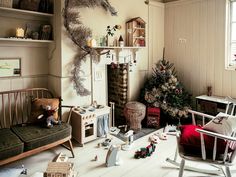 a living room filled with furniture and a christmas tree