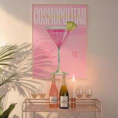 there is a pink poster on the wall next to some wine glasses and two bottles