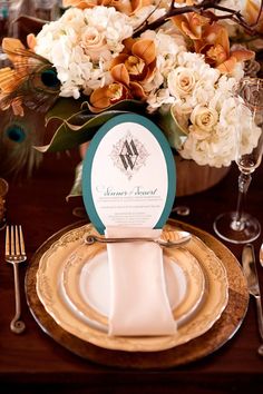 a table setting with place settings and flowers