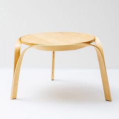 a small wooden table sitting on top of a white floor