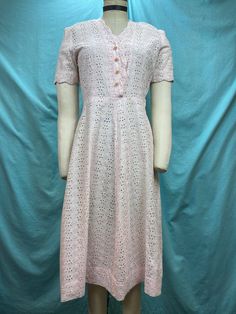 1940s W:27 vintage 40s pink embroidery eyelet cottton shirt dress pearl shank buttons short sleeve  Beautiful 40s vintage dress. Made out of light weight cotton with eyelets and roses embroidery in light powder pink color. Classic shirt dress with scalloped edge V neckline and short sleeves. Hiked natural waist and A-line skirt. Dress with side zipper and non functional pearl shank buttons. Unlined. Photographed on fit form size 2. MEASUREMENTS  Bust: 36" Waist: 27" Hips: 44" Shoulder to waist: Feminine Eyelet Dress With Short Sleeves, Short Sleeve Eyelet Dress For Daywear, Pink Short Sleeve Dress With Buttons, Summer Vintage Dress With Buttons And Short Sleeves, Feminine Vintage Short Sleeve Dress For Daywear, Feminine Short Sleeve Vintage Dress For Daywear, Classic Short Sleeve Vintage Summer Dress, Short Sleeve Vintage Dress For Summer, 1950s Style Short Sleeve Day Dresses