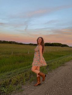 Summer dress, cowboy boots outfit, summer outfit inspo, field photoshoot Boots With Sundress, Brown Cowboy Boots Dress Outfit, Sundress Cowboy Boots Summer Outfits, Dress And Brown Cowboy Boots Outfit, Sun Dress With Boots, Sun Dress Cowboy Boots, Brown Country Boots Outfits, Summer Dress And Cowboy Boots, Brown Cowgirl Boots Outfit Summer