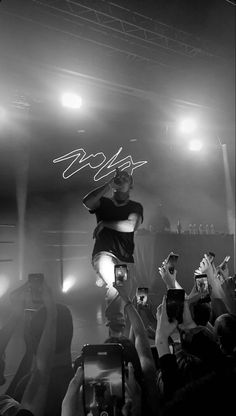 a person jumping in the air on top of a stage