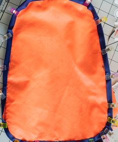 an orange and blue bag sitting on top of a table