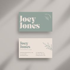 two business cards with green leaves on the front and back, both printed in white ink