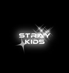 the words stray kids are lit up against a black background with white stars and sparkles