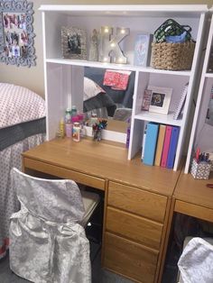 a desk and chair in a room with a book shelf on the wall above it