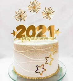 a white cake with gold numbers and stars on top