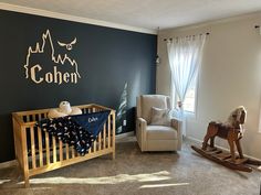 a baby's room with rocking horse, rocking chair and crib in it