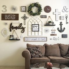 a living room filled with lots of different types of decor on the wall above a couch